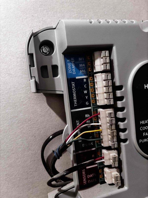Responded to service call for reported thermostat issue with air conditioning system on 10-year-old Payne unit. Upon arrival, inspected Emerson digital thermostat mounted on exterior wall and examined zone control panel with damper and sensor connections. Verified thermostat display functionality, checked wiring connections at both thermostat and zone control terminal blocks, and confirmed proper voltage at R and C terminals. System demonstrated ability to cool as reported by customer. Photographed thermostat interface and zone control wiring configuration for documentation. All connections secure, no immediate faults identified during inspection.
