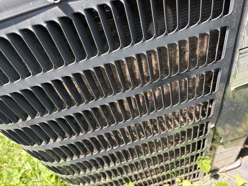 # CP-Cooling Problem Resolution

Responded to service call for AC system running continuously but struggling to maintain temperature, with indoor conditions rising to 72°F and climbing. Upon arrival, performed visual inspection of 4-year-old outdoor condensing unit.

Inspection revealed heavy accumulation of yellow-green pollen and organic debris significantly coating the condenser coil fins, particularly concentrated on multiple sections of the coil surface. This contamination was restricting proper airflow through the heat exchanger, reducing the system's cooling capacity and efficiency. External housing also showed signs of weathering and discoloration consistent with outdoor exposure.

Documented equipment condition through photographic evidence showing the extent of coil contamination and overall unit condition. The debris buildup was substantial enough to impair heat transfer and cause the system performance issues reported by the customer.

Cleaning and restoration of condenser 