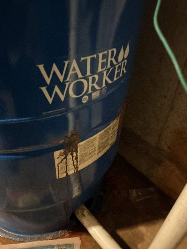 Responded to a slow leak at well pressure tank in a 55-year-old residential property. Upon inspection, discovered active leak at pressure tank connection point that had likely been occurring for 1-2 weeks based on visible water damage and mineral deposits around the affected area. The system consisted of a Water Worker brand pressure tank with copper and PVC plumbing connections, pressure control unit, and associated shut-off valves.

Isolated the well system using the existing shut-off valves and depressurized the tank to safely access the leak source. Identified the leak originating from a compromised fitting connection between the copper supply line and the pressure tank inlet. Removed the faulty connection, cleaned and prepared pipe threads, and installed new brass fitting with proper thread sealant and torque specifications. Verified all surrounding connections for integrity and tightened the blue manual valve that showed signs of minor seepage.

Restored water pressure to the sys