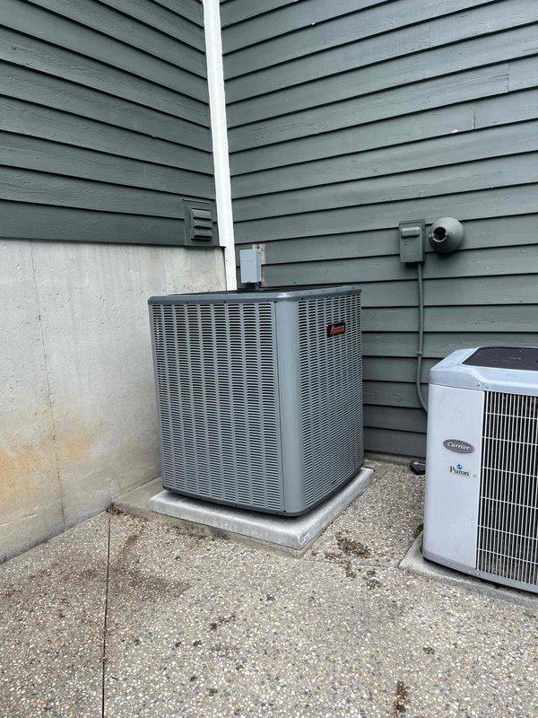 Completed full residential HVAC system replacement including installation of new Carrier outdoor condensing unit and indoor furnace assembly in basement utility area. Installed new white PVC condensate drainage piping, connected ductwork transitions, and mounted all equipment on appropriate platforms with proper electrical connections and refrigerant line sets. System tested and verified operational upon completion.