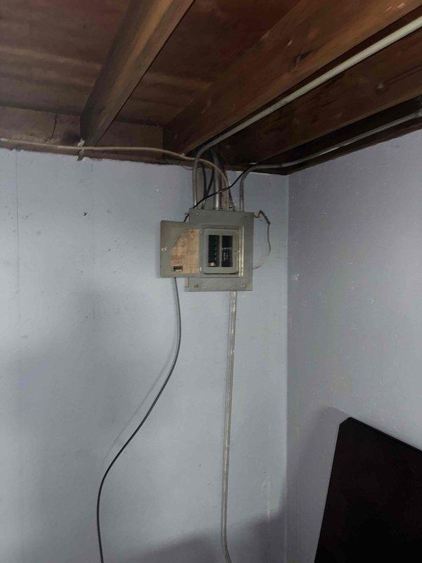 Conducted on-site evaluation for new air conditioning system installation in residential property with no existing HVAC cooling equipment. Assessed basement utility area to determine optimal placement for indoor air handler unit and reviewed existing electrical infrastructure including main breaker panel and available power supply for new AC system requirements. Documented current conditions of installation area including ceiling joist structure, wall space availability, and electrical service capacity to develop comprehensive equipment and installation estimate for complete central air conditioning system.