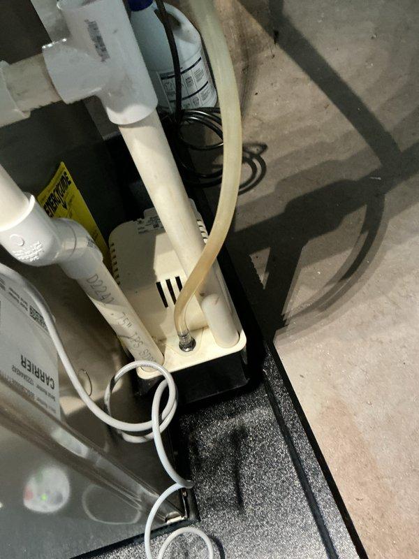 Completed annual cooling system tune-up on 16-year-old air conditioning unit. Performed comprehensive inspection of all mechanical components, verified refrigerant levels, checked electrical connections, and tested system operation. Documented existing plumbing infrastructure including condensate drainage system with pump assembly and aging copper supply lines showing corrosion, which may require future attention.