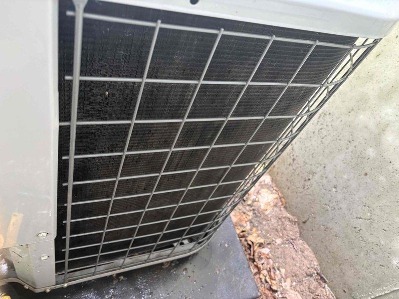 Responded to service call for elevated indoor humidity readings and reduced cooling efficiency. Upon arrival, performed comprehensive system inspection of 9-year-old air conditioning unit. Found outdoor condenser unit with significant debris accumulation around base and restricted airflow through condenser coil fins. Removed organic debris including decomposed leaves and plant material from unit perimeter and cleaned condenser coil to restore proper airflow. Verified condenser fan operation and refrigerant pressures within normal parameters. Inspected indoor evaporator coil and drain system for proper condensate removal. System operating within manufacturer specifications following cleaning and debris removal, with improved airflow and heat transfer efficiency restored to condenser unit.