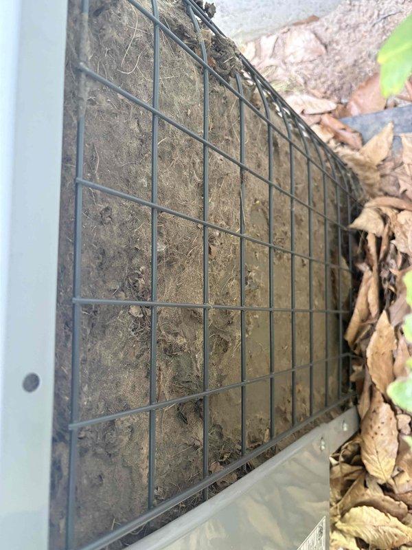 Responded to service call for elevated indoor humidity readings and reduced cooling efficiency. Upon arrival, performed comprehensive system inspection of 9-year-old air conditioning unit. Found outdoor condenser unit with significant debris accumulation around base and restricted airflow through condenser coil fins. Removed organic debris including decomposed leaves and plant material from unit perimeter and cleaned condenser coil to restore proper airflow. Verified condenser fan operation and refrigerant pressures within normal parameters. Inspected indoor evaporator coil and drain system for proper condensate removal. System operating within manufacturer specifications following cleaning and debris removal, with improved airflow and heat transfer efficiency restored to condenser unit.