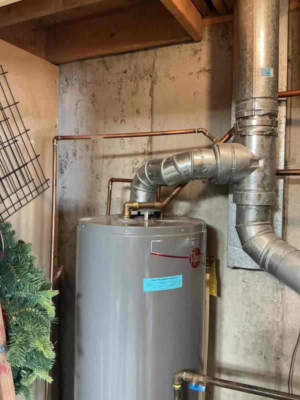 Conducted estimate for water heater replacement in condominium basement utility area. Existing unit is approximately 10 years old with no current leaks or operational issues reported. Documented existing installation including water heater configuration, copper supply lines, venting system, and surrounding ductwork for replacement planning purposes.