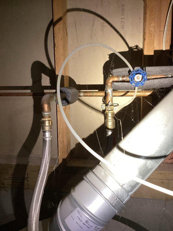 Responded to no hot water call at residential property. Upon arrival, inspected water heater system located in crawl space/basement area. Found water heater approximately 10 years old with complete loss of hot water throughout entire house. Examined plumbing connections, including copper supply lines with insulation, shutoff valves, and flexible connectors. Assessed HVAC ductwork and ventilation system in attic space above water heater location. Documented existing installation with copper piping, blue-handled shutoff valve, braided flex lines, and electrical connections. Evaluated overall system condition and provided recommendations for service or replacement based on age and operational status of unit.