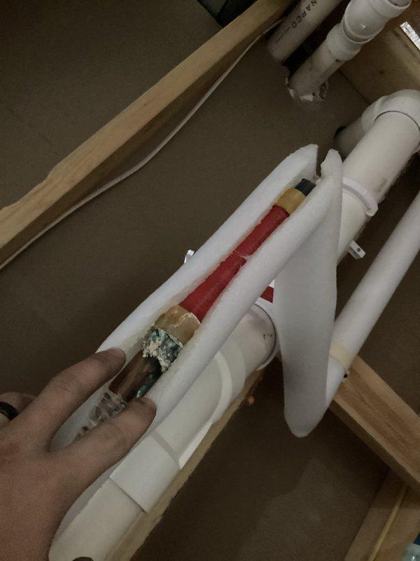 Responded to complaint of sporadic hot water and loss of heat mid-shower in five-year-old home. Upon inspection, discovered significant corrosion and mineral buildup on copper piping connections at water heater inlet. Identified compromised fitting restricting water flow to unit, causing inadequate hot water delivery throughout residence. Documented existing plumbing configuration including expansion tank and valve assembly. Recommended immediate replacement of corroded copper fittings and evaluation of water heater dip tube for potential deterioration contributing to inconsistent hot water supply.