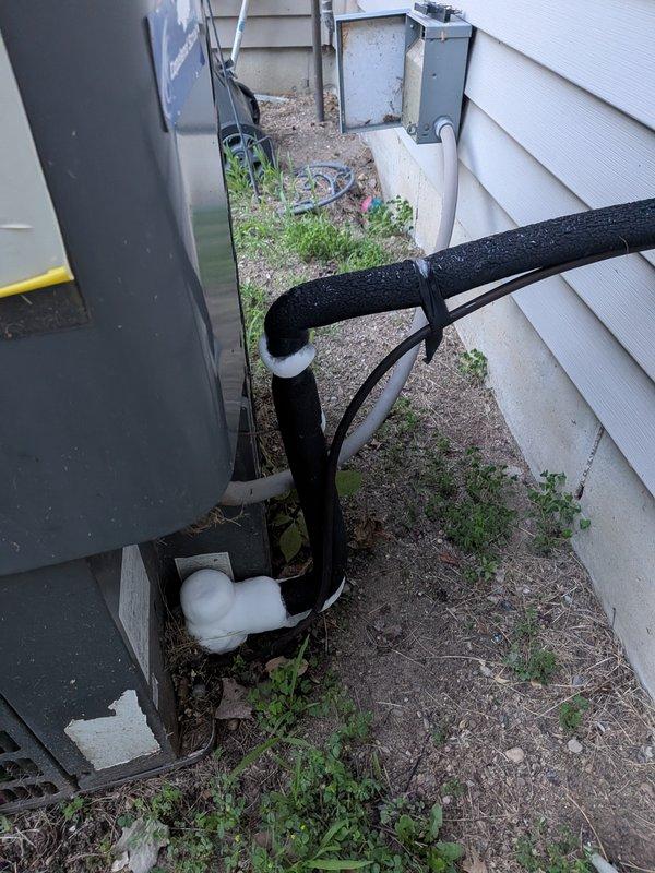 Responded to no cooling call on residential air conditioning system. Upon arrival, performed diagnostic inspection of outdoor condensing unit and refrigerant lines. Identified significant corrosion on evaporator coil fins and deterioration of system components affecting heat transfer efficiency. Applied rust inhibitor treatment to affected metal brackets and support structures to prevent further degradation. Inspected refrigerant line insulation in exterior service corridor and verified proper installation of line set between buildings. System components showing advanced age-related wear requiring treatment to restore cooling capacity. Documented equipment condition with photos for service records.