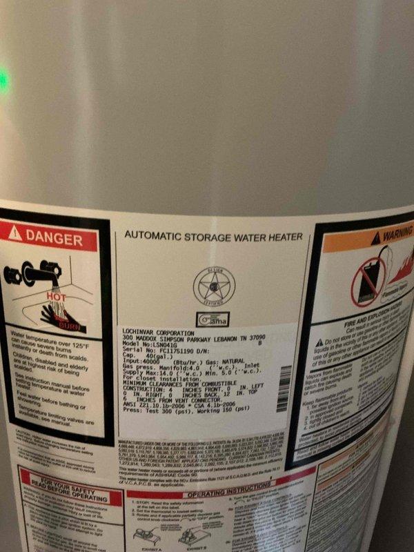 Completed water heater replacement estimate for residential property with 20-year-old Lochinvar unit showing significant corrosion on copper pipe connections and fittings at top of tank. Documented existing installation conditions including corroded hot and cold water connections, yellow flexible gas line, and metallic vent flue system, with recommendation for immediate replacement due to age and deterioration of plumbing connections.