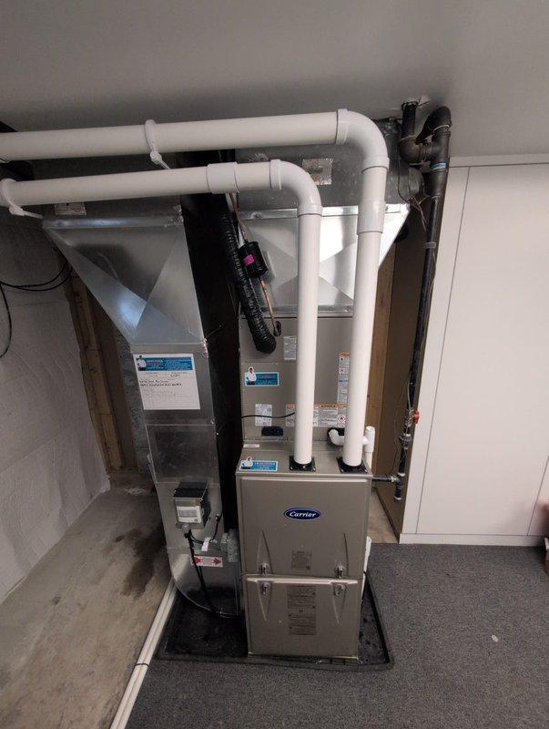 Completed full air conditioning system replacement including installation of new Carrier furnace and air handler unit in basement mechanical room. Installed outdoor condensing unit on concrete pad in backyard with proper refrigerant line connections and electrical hookup. Routed new PVC ventilation piping, completed all electrical connections, tested system operation, and verified proper airflow and cooling performance throughout residence.
