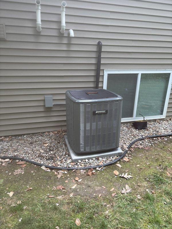 Completed full HVAC system replacement including removal of existing equipment and installation of new Luxaire furnace in basement utility area and matching outdoor condensing unit. Installed refrigerant line set with proper insulation, established all electrical connections with disconnect box, and ran PVC condensate drainage lines with appropriate venting. Positioned outdoor unit on concrete pad with gravel surround for proper drainage and clearance. System tested and verified operational with all safety controls functioning correctly.