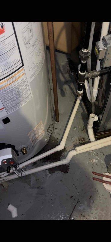 Responded to reported water leak concern at property with 8-year-old AC unit and 9-year-old furnace (EnergiAir systems with warranties through 2027-2028). Upon inspection, examined HVAC system components including air filter and blower assembly, which showed normal dust accumulation consistent with system age. Inspected utility room area including water heater, PVC drainage lines, and concrete floor surfaces. Documented visible water staining and moisture patterns on floor near mechanical equipment. Verified heating system remained operational during inspection. Photographed filter condition, blower housing, water heater installation, and floor areas showing staining to document current system condition and identify potential leak source for further evaluation.