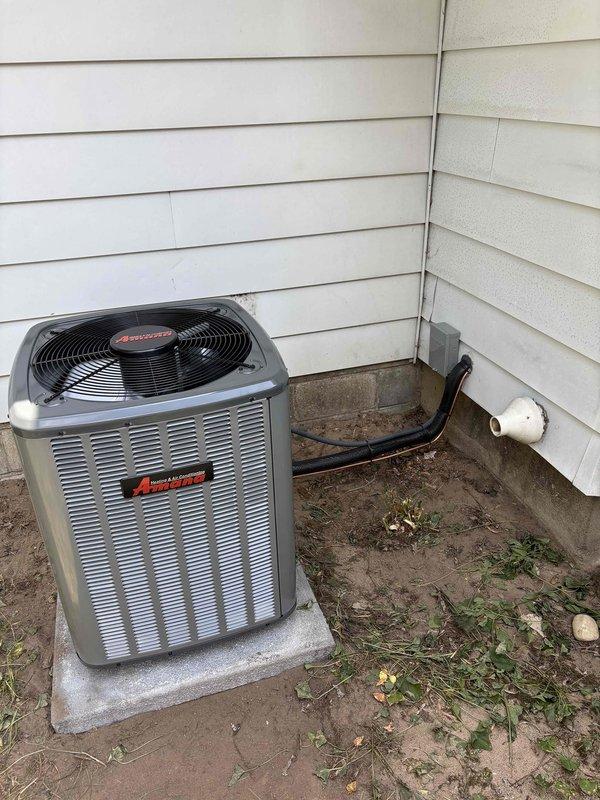 Completed full air conditioning system replacement including outdoor condensing unit and indoor air handler components. Installed new Amana condenser unit on existing concrete pad with proper clearances from exterior walls. Connected refrigerant lines, electrical service, and condensate drainage system with new PVC piping routed to appropriate discharge location. Mounted and secured indoor air handler adjacent to existing furnace in basement utility area with properly installed flexible ductwork connections. Verified all electrical connections, tested system startup and operation, confirmed proper refrigerant charge and airflow, and ensured all components functioning within manufacturer specifications.