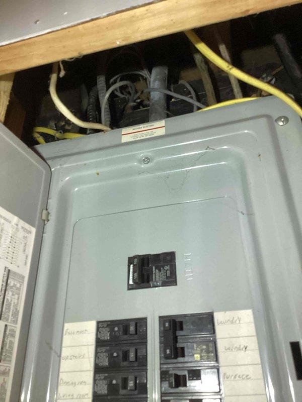 Conducted on-site assessment for adding a new AC unit to existing central air system. Evaluated electrical panel capacity and existing infrastructure to determine feasibility of additional air conditioning equipment installation. Documented current electrical panel configuration, available breaker spaces, and wire routing through ceiling joists to support estimate preparation for new AC unit addition.