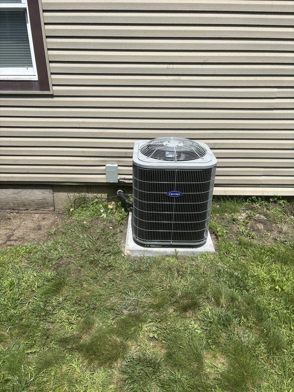 Completed full HVAC system replacement at residential property. Removed existing air conditioning system and installed new Carrier outdoor condensing unit on existing concrete pad in side yard. Unit positioned adjacent to house with proper clearance and connected via electrical conduit running from exterior wall. Outdoor unit features protective grille and efficient condenser coil design.

Inside the home, installed new Goodman gas furnace in utility closet. Unit properly mounted and secured with all required PVC condensate drain lines and venting components connected at base. Integrated flexible ductwork routed from furnace for proper air distribution throughout residence. All electrical connections completed to code specifications. System tested for proper operation including airflow, refrigerant pressures, and safety controls. Installation meets manufacturer specifications and local building codes.