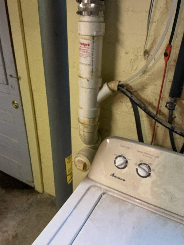 Responded to call regarding strong septic odor in residence. Conducted thorough inspection of utility area and basement plumbing infrastructure. Examined washing machine drain connections, PVC drainage system, and water treatment equipment for potential sources of sewer gas infiltration. Inspected overhead plumbing including drain lines and vent pipes for proper configuration and potential trap seal failures. Photographed existing conditions including utility room plumbing configuration and basement ceiling infrastructure showing drain and vent pipe routing. No immediate plumbing failures or leaks identified during visual inspection. Advised client on potential causes of septic odors including dry trap seals, compromised vent stack, or issues with septic system itself requiring further specialized evaluation.