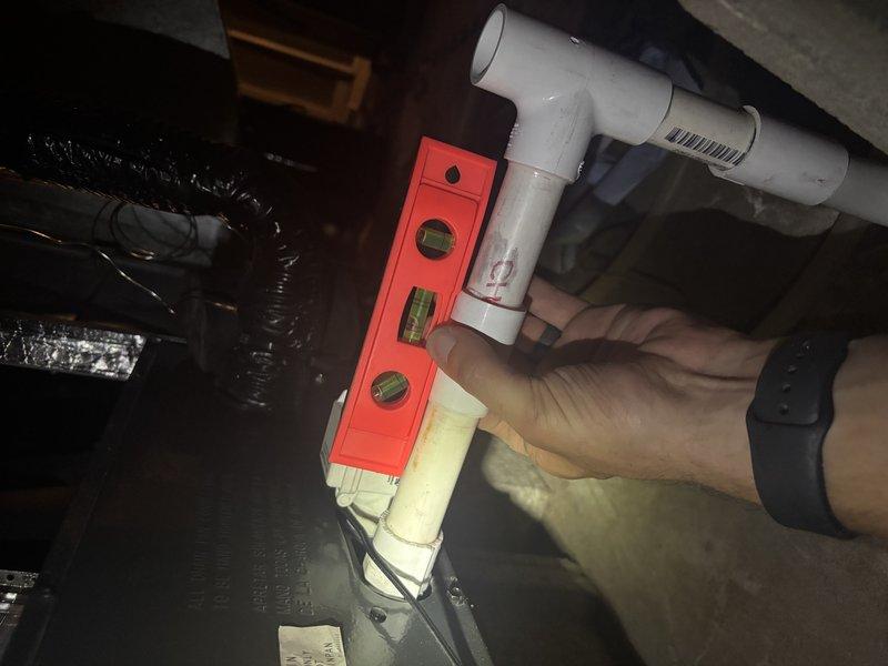 Responded to cooling complaint on 1-year-old ENE WT 2-2035 system unable to maintain temperature below 73°F. Upon inspection, discovered condensate drain line improperly pitched, preventing adequate drainage and triggering safety float switch that was intermittently shutting down the system. Re-leveled and secured PVC drain line to proper slope using appropriate hangers and verified unrestricted water flow. Tested system operation through complete cooling cycle, confirmed proper drainage, and verified unit now cooling effectively to setpoint.