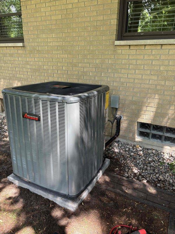 Completed full air conditioning system replacement including outdoor condenser unit and indoor air handler. Removed existing equipment and installed new Amana condenser unit on exterior concrete pad with proper electrical disconnect and conduit connections. Installed new furnace/air handler in basement mechanical room with associated ductwork connections, PVC condensate drainage piping, and electrical components. Verified all refrigerant line sets, ductwork transitions, and insulation were properly secured. System tested and confirmed operational with proper airflow and cooling performance.
