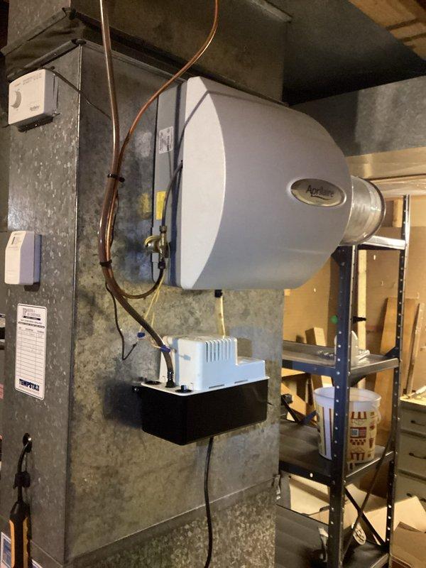 Completed annual cooling maintenance on 18-year-old ICP air conditioning system. Performed comprehensive inspection of indoor air handler components including blower motor assembly, refrigerant lines, and electrical connections. Verified proper operation of humidifier unit mounted on supply plenum and confirmed condensate pump functionality with clear drainage. All system components operating within normal parameters at time of service.