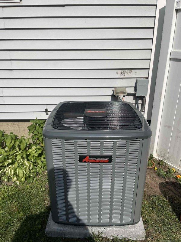 Completed full HVAC system replacement including installation of new Amana air conditioning condenser unit and Carrier furnace. The outdoor condenser was positioned on a level concrete pad with proper clearance from the building and vegetation, with refrigerant lines professionally routed through the exterior wall. Inside the mechanical room, installed the new Carrier furnace with complete ductwork connections to the existing metallic supply plenum, integrated all necessary PVC condensate drainage, and ensured proper electrical and gas connections. All equipment was tested for proper operation, refrigerant levels verified, and system commissioned to manufacturer specifications.