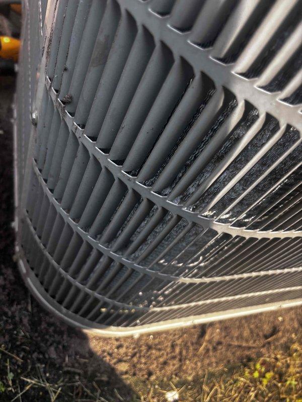 Completed annual cooling maintenance on 19-year-old Bryant air conditioning system. Performed comprehensive tune-up including inspection of condenser unit, coils, and all operational components. Condenser coil showed moderate to heavy accumulation of dirt and debris, particularly in lower sections, with visible corrosion and rust present on metal surfaces. Documented equipment condition with photos showing oxidation and buildup affecting heat transfer efficiency. System operational at time of service completion.