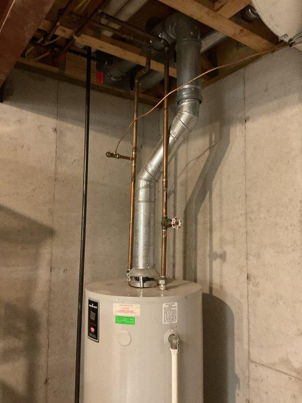 Responded to no-cooling call on 21-year-old Bryant system where furnace fan was operating but outdoor unit showed no activity. Performed diagnostic evaluation of split system HVAC equipment located in basement utility area. Documented equipment condition and system configuration with photos showing furnace, air handler, and associated ductwork installation. Provided estimate for necessary repairs to restore outdoor unit operation and complete system functionality.