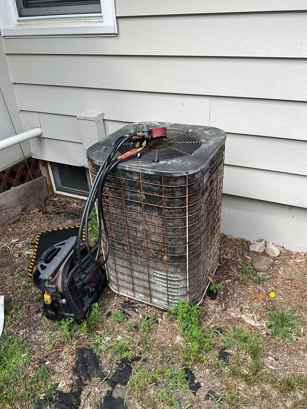 Responded to no cooling complaint on approximately 20-year-old residential air conditioning system. Upon arrival, performed visual inspection of outdoor condenser unit, which showed significant age-related deterioration including rust, corrosion, and weather damage throughout the cabinet and fan grille. Assessed electrical connections and refrigerant line set configuration at service ports. Documented existing conditions of aged equipment and outdoor installation environment. Unit's advanced age and extensive wear indicate system is well beyond typical service life expectancy.