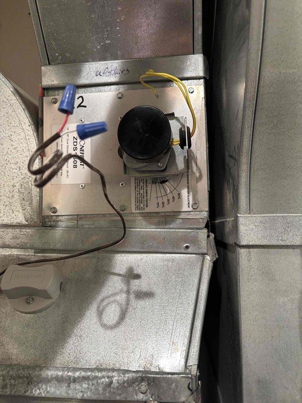 Responded to callback for zoned air conditioning system with cold air discharging into incorrect zone after previous repair attempt. Inspected 12-year-old Payne zoned HVAC system and identified malfunctioning zone damper motor assembly. Found Zone 2 damper actuator failing to maintain proper position, causing airflow to redirect after initial cycling. Verified damper motor wiring connections, tested actuator operation through multiple cycles, and confirmed proper zone control board signaling. Corrected damper linkage positioning and secured all electrical connections at zone control panel. Cycled system through all zone calls to verify proper damper operation and airflow distribution to designated areas. System now operating correctly with airflow directing to appropriate zones as called for by respective thermostats.