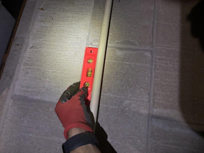 Responded to service call for water leak from furnace and air conditioning system not cooling properly. Inspected outdoor heat pump unit and identified condensate drainage issue. Verified proper leveling of condensate drain line using torpedo level to ensure adequate pitch for water flow. Addressed water leak concern and restored system to proper operating condition.