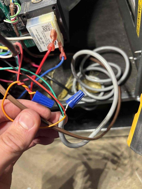 Responded to no cooling call on newly installed EnergiAir system where indoor fan was operating but compressor would not engage. Upon inspection, discovered improper low-voltage wiring connections at the air handler control board. Multiple thermostat wires were incorrectly terminated using wire nuts instead of being properly landed on the control board terminals. Corrected all low-voltage wiring by removing wire nuts, identifying proper wire functions, and securing connections directly to appropriate terminals on the control board according to manufacturer specifications. Verified all wire colors matched their designated functions for proper thermostat communication. Tested system operation and confirmed compressor engaged properly with correct cooling cycle initiation. System now cooling normally with all components functioning as designed.