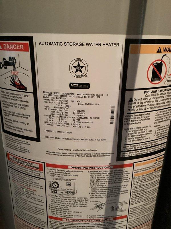 Installed a 50-gallon natural draft Bradford White natural gas water heater in basement utility area. Unit was properly connected to existing gas line and plumbing infrastructure with copper supply lines and appropriate venting, placed on drip pan per code requirements, and tested for proper operation. Installation includes 6-year parts and 1-year labor warranty coverage.
