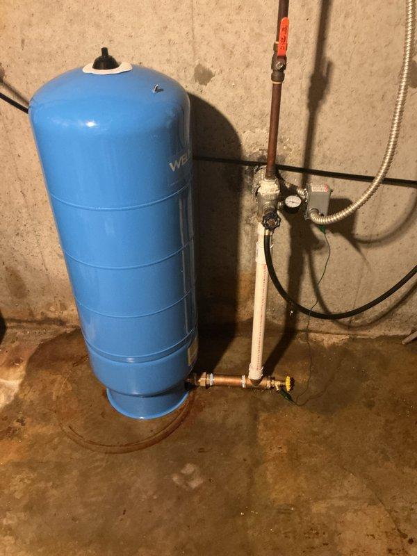 Returned to property to complete installation of new well bladder pressure tank as quoted. Removed existing failed tank and installed new Well-X-Trol blue pressure tank with proper mounting and connections. Connected tank to existing well system using copper piping and brass shut-off valves, installed pressure gauge for system monitoring, and integrated red-handled isolation valve on PVC supply line. Tested system operation, verified proper pressure settings, and confirmed no leaks at all connection points.