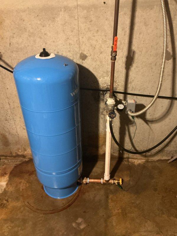Returned to property to complete installation of new well bladder pressure tank as quoted. Removed existing failed tank and installed new Well-X-Trol blue pressure tank with proper mounting and connections. Connected tank to existing well system using copper piping and brass shut-off valves, installed pressure gauge for system monitoring, and integrated red-handled isolation valve on PVC supply line. Tested system operation, verified proper pressure settings, and confirmed no leaks at all connection points.