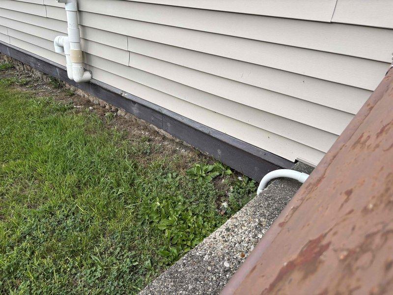 Responded to emergency call for water spraying from top of 15-year-old water heater in basement with stone foundation. Upon inspection, identified failed temperature and pressure relief valve as source of leak. Shut off water supply, drained unit partially, replaced defective T&P valve, and tested system for proper operation and no additional leaks.