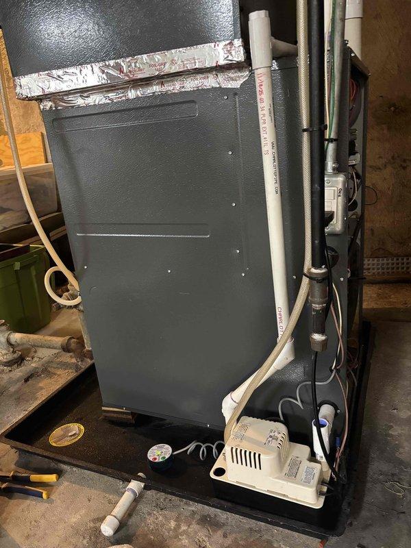 Responded to water leak call caused by failed AC condensate pump at HVAC system. Replaced malfunctioning condensate pump to restore proper drainage from air handler unit. Verified leak sensor operation and confirmed system draining correctly with no further water accumulation.