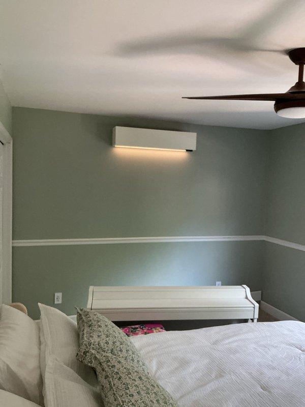 Completed installation of multi-zone ductless mini-split system in residential property. Installed indoor wall-mounted air handler units in multiple rooms including office/living area with decorative tin ceiling and bedroom with crown molding. Mounted units at optimal heights for efficient air distribution, ensuring proper clearance from ceiling and adequate drainage routing. Verified electrical connections, refrigerant line sets, and condensate drainage for all zones. Tested system operation across all indoor units, confirmed proper cooling function, and programmed individual zone controls. System commissioned and left fully operational per manufacturer specifications.
