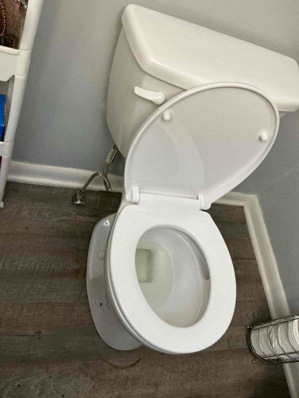Completed installation of customer-provided white porcelain toilet in residential bathroom. Secured unit to floor with standard mounting hardware, connected water supply line, and verified proper flush operation and bowl refill. Toilet is fully functional with no leaks detected at base or supply connection.