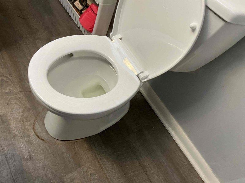 Completed installation of customer-provided white porcelain toilet in residential bathroom. Secured unit to floor with standard mounting hardware, connected water supply line, and verified proper flush operation and bowl refill. Toilet is fully functional with no leaks detected at base or supply connection.