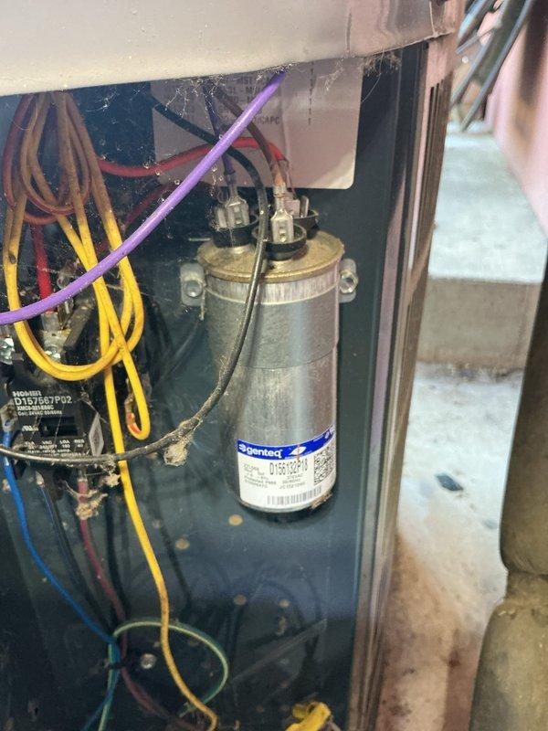 # NC-No Cool Service Completed

Responded to no cooling call with furnace fan operating but outdoor unit buzzing without compressor engagement. Upon inspection, found outdoor condenser unit experiencing electrical failure preventing compressor startup. Accessed outdoor unit and identified failed dual-run capacitor showing visible signs of deterioration, corrosion, and age-related failure. Capacitor tested out of specification and unable to provide necessary starting voltage to compressor motor, resulting in characteristic buzzing sound without rotation.

Removed defective capacitor and installed new dual-run capacitor with proper microfarad ratings for both compressor and condenser fan motor. Secured all electrical connections, verified proper wire routing, and ensured terminals were tight. Energized system and confirmed compressor started smoothly without buzzing. Verified condenser fan motor operation and proper amperage draw on both compressor and fan motor. Monitored system through