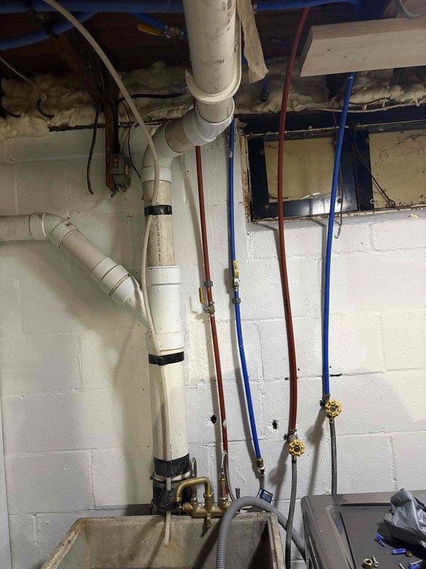 Installed new laundry tub faucet and shower trim kit in basement utility area. All fixtures tested and confirmed operational with no leaks detected upon completion.