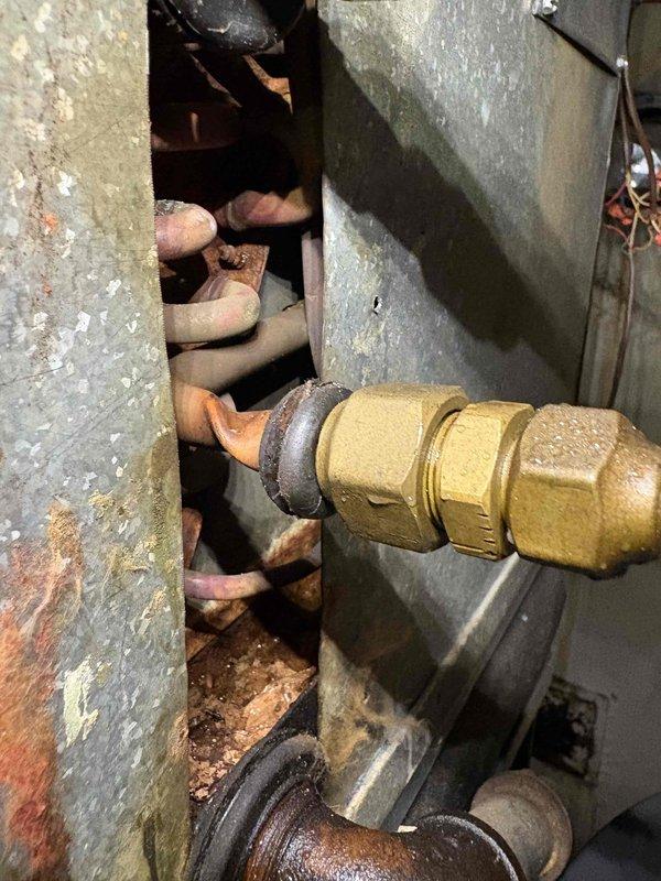 Responded to no cooling complaint on residential air conditioning system. Upon arrival, conducted thorough inspection of HVAC unit and associated components. Examined refrigerant lines, gas connections, and mechanical fittings in utility area. Observed aging copper piping with corrosion and oxidation, brass compression fittings showing surface wear, and corrugated stainless steel flexible gas line with proper thread seal tape application. Documented existing conditions of plumbing infrastructure and connections to heating/cooling equipment. Verified all gas line connections were secure with appropriate sealing. System evaluated for proper airflow and mechanical operation. Photos captured of pipe connections, brass fittings, and utility area components for service records. Unit restored to normal cooling operation.
