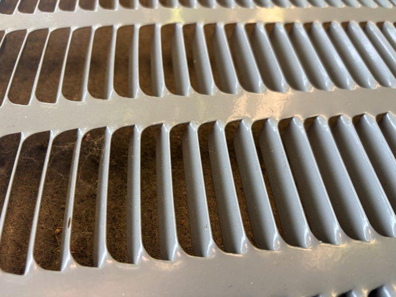 Responded to service call for EnergiAir split system that experienced intermittent cooling failure with outdoor condenser unit shutting down during operation. Upon arrival, customer reported unit had ceased producing cold air but resumed normal operation after being cycled off and restarted. Inspected system components and documented significant dust and debris accumulation on indoor air return grilles and ventilation components, which can restrict airflow and contribute to system overheating and intermittent shutdown conditions. Unit was operational at time of inspection with cold air output restored. Recommended thorough cleaning of air filters and return vents to maintain proper airflow and prevent future thermal overload conditions that may cause condenser shutdown.