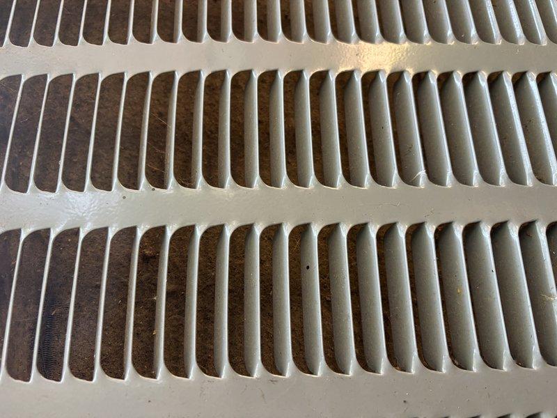 Responded to service call for EnergiAir split system that experienced intermittent cooling failure with outdoor condenser unit shutting down during operation. Upon arrival, customer reported unit had ceased producing cold air but resumed normal operation after being cycled off and restarted. Inspected system components and documented significant dust and debris accumulation on indoor air return grilles and ventilation components, which can restrict airflow and contribute to system overheating and intermittent shutdown conditions. Unit was operational at time of inspection with cold air output restored. Recommended thorough cleaning of air filters and return vents to maintain proper airflow and prevent future thermal overload conditions that may cause condenser shutdown.