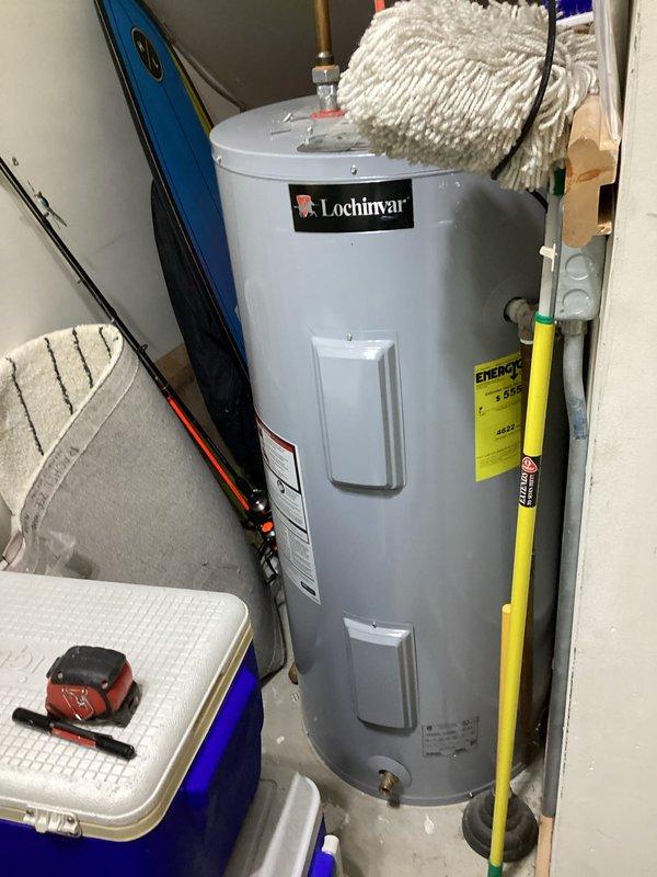 Conducted on-site assessment for tankless water heater installation at a 40-year-old residential property. Evaluated existing utility room layout, photographed current conventional tank-style Lochinvar water heater, documented available space and existing plumbing infrastructure including visible PVC drainage systems and supply piping connections. Provided comprehensive quote for new tankless water heater system installation including necessary modifications to gas lines, venting requirements, and electrical connections to support tankless unit operation.