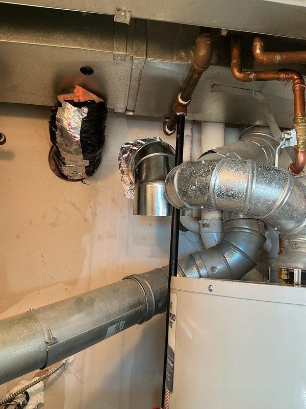 Responded to inspection correction notice regarding inadequate combustion air for water heater located in confined utility closet. Assessed existing ventilation configuration and determined combustion air supply was insufficient per code requirements for gas-fired appliance operation. Installed proper combustion air openings and verified adequate airflow to support safe combustion and prevent potential hazardous conditions in enclosed mechanical space.