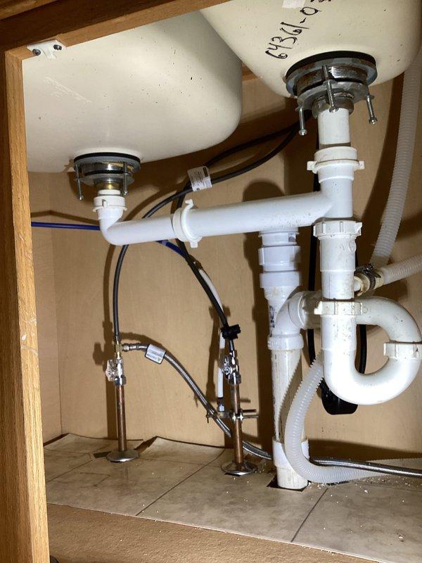 Responded to kitchen sink stoppage issue that worsened after previous service attempt. Inspected double-sink drain assembly and P-trap configuration under cabinet to locate obstruction that previous contractor was unable to find. Successfully cleared blockage and restored proper drainage function. Additionally assessed two bathroom sink drain receivers for replacement as requested.