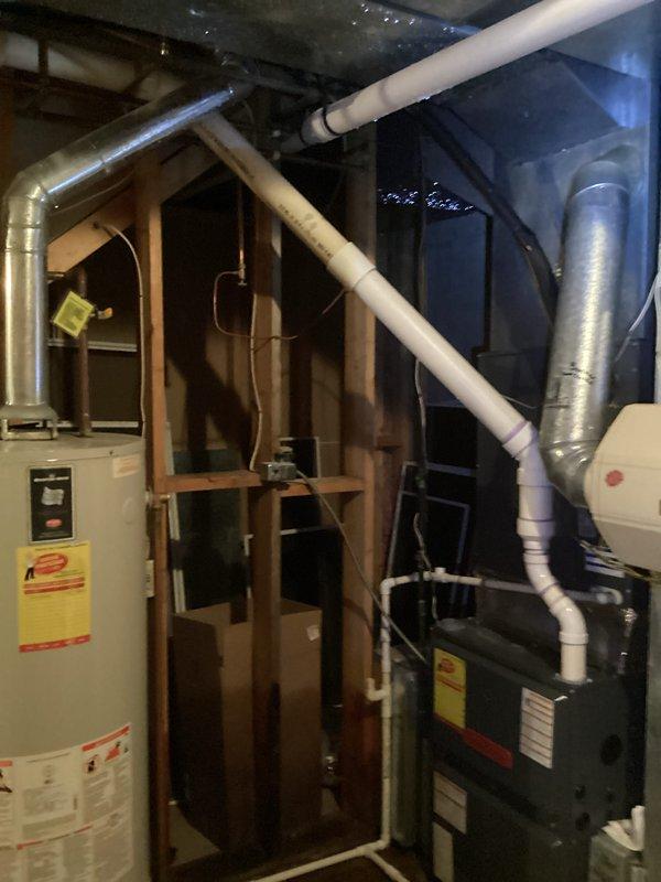 # Water Heater Leak Repair

Responded to service call for water leaking from top of 25-year-old Bradford White water heater. Upon arrival, inspected the unit and confirmed active leak originating from upper connections. Given the age of the equipment and extent of deterioration, recommended complete water heater replacement. Documented existing installation conditions including plumbing connections, venting configuration, and surrounding mechanical systems. Photographed the water heater, adjacent furnace, exposed framing, and associated piping infrastructure including copper supply lines, PVC drainage, and flexible metallic ductwork in the unfinished basement utility area. Provided customer with assessment and replacement options for aging water heater system.
