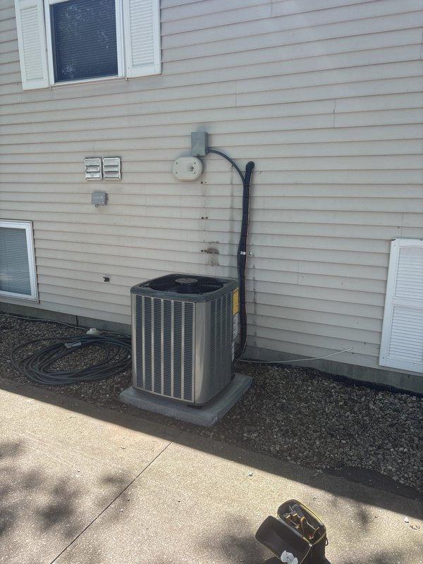 Successfully completed full HVAC system installation including new furnace and air conditioning unit. Installed black air handler unit with gray furnace in basement mechanical room with proper clearances and professional ductwork connections. Exterior condenser unit mounted on concrete pad with electrical disconnect, conduit, and proper utility connections installed per code. All PVC condensate drain lines, refrigerant lines, and electrical connections completed. System tested and verified operational. Installation includes organized piping runs, adequate equipment clearances, and all manufacturer specifications met for residential heating and cooling system.