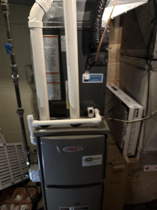 Completed full HVAC system installation including Lennox furnace unit in basement utility area and outdoor condensing unit. Connected all PVC venting, refrigerant lines, ductwork, and electrical components per manufacturer specifications. Properly charged system with refrigerant, documented field charge levels, verified all safety labels and warnings in place, and confirmed operational performance of complete heating and cooling system.