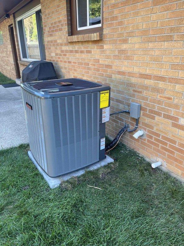 Completed full HVAC system installation including new air handler unit in basement utility room and outdoor condensing unit. Installed all refrigerant line sets with proper mounting brackets, connected ductwork to existing ventilation system, and ran electrical disconnect and PVC condensate drainage. Positioned outdoor unit on concrete pad against exterior wall with proper clearances, secured all refrigerant lines and electrical connections, and verified system operation upon startup.